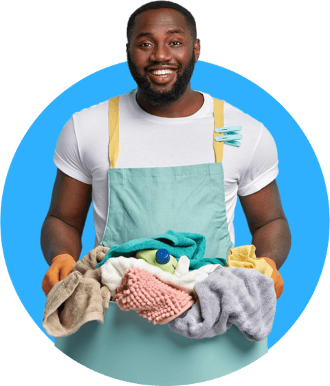 A smiling Duffloo Washer Hero holding a basket of freshly washed laundry