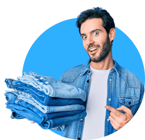 A happy Duffloo customer holding a stack of freshly folded jeans